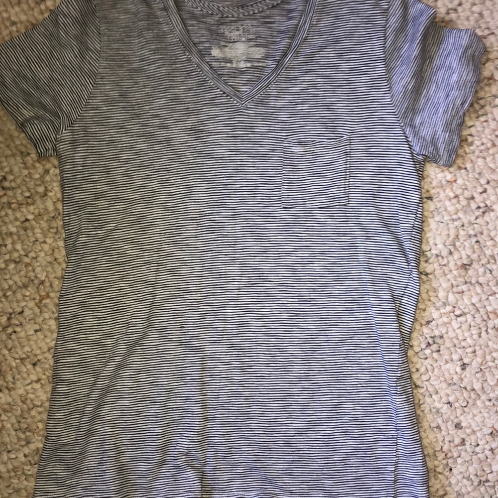 a white and black striped tee with a chest pocket.